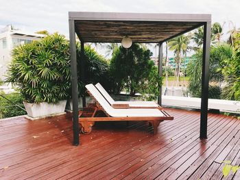 Empty chairs and tables against building