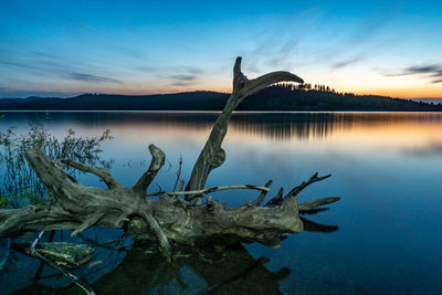 Scenic view of lake against sky during sunset