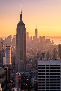 High angle view of empire state buildings in city during sunset