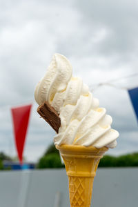 Close-up of ice cream cone against white background