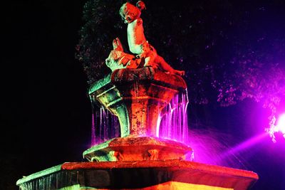 Low angle view of illuminated ferris wheel