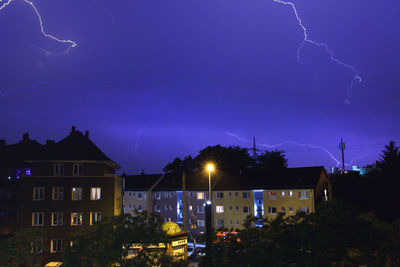 Low angle view of illuminated lights at night