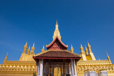 Low angle view of temple building against blue sky