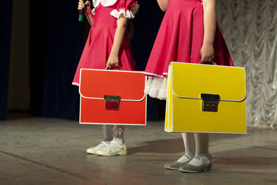 Girls with school bags. schoolgirls in dresses. bright clothing accessories for children.