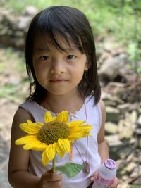 Portrait of young woman holding flower