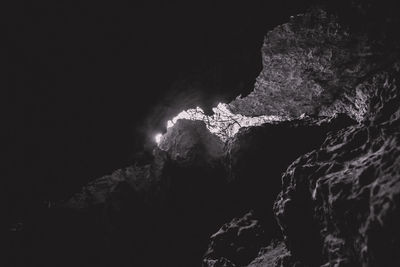 Low angle view of rock formations against sky at night