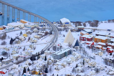 High angle view of snow covered city against sky