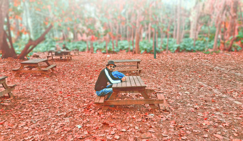 Man sitting on bench in park