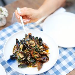 Cropped hand of woman holding food