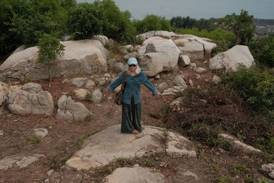Rear view of man standing on rock