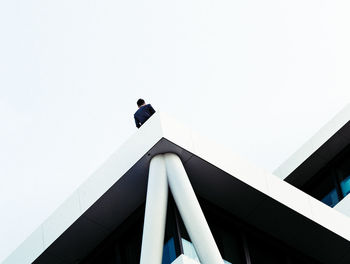 Low angle view of person against clear sky