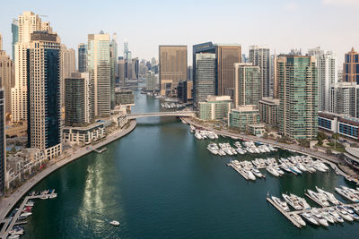 High angle view of river amidst buildings in city against sky