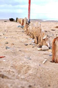 Stones at beach against sky