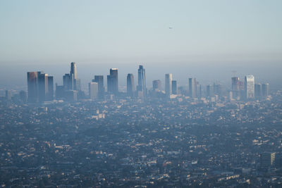 Aerial view of modern buildings in city against sky