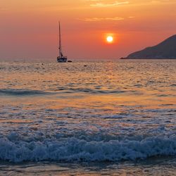 Scenic view of sea against orange sky during sunset