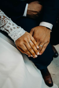 Midsection of couple holding hands