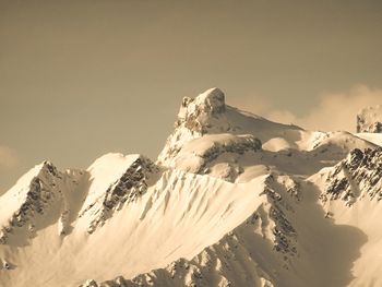 Scenic view of snow covered mountains against sky