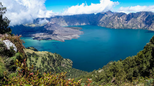 Panoramic view of sea and mountains against sky