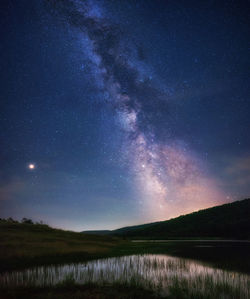 Scenic view of lake against star field at night