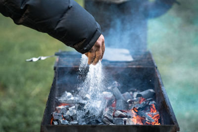 Man preparing food on barbecue grill