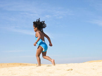 Woman jumping on beach