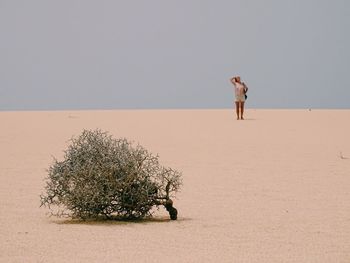 Full length of woman standing on beach