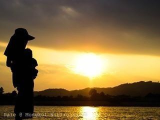 sunset, silhouette, water, sky, sun, scenics, mountain, beauty in nature, tranquility, tranquil scene, orange color, lake, idyllic, nature, leisure activity, reflection, lifestyles, standing