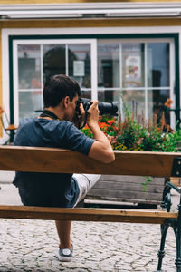 Full length of man photographing at camera