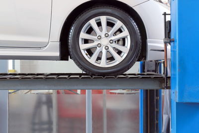 Close-up of car on lift in garage