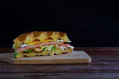 Close-up of breakfast on table against black background