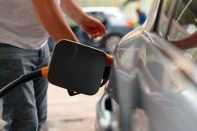 Hand man refill and filling oil gas fuel at station.