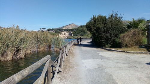 Footbridge over road against clear sky