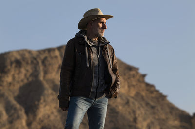 Adult man in cowboy hat in tabernas desert, almeria, spain