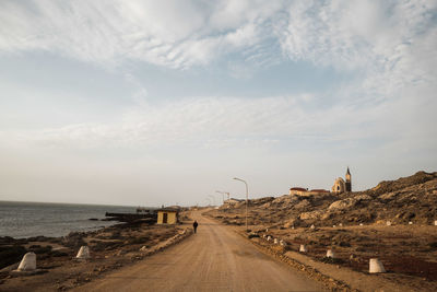 Road by sea against sky