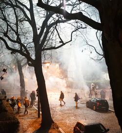 Group of people on city street during foggy weather