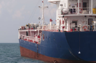 Ship moored on sea against sky
