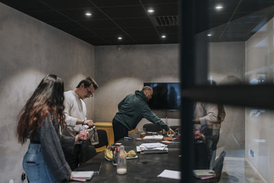 Multiracial male and female entrepreneurs in board room at creative office