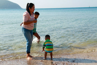 Full length of women standing on beach