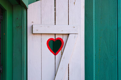 Red heart shape on blue door