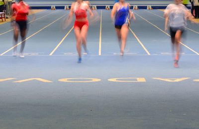 Group of people running on road