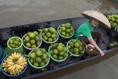 High angle portrait of boy in boat at floating market