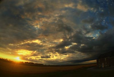 Scenic view of dramatic sky at sunset