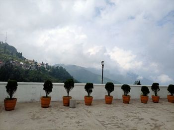 Rear view of people at beach against sky