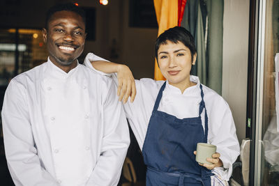 Portrait of smiling couple standing in office