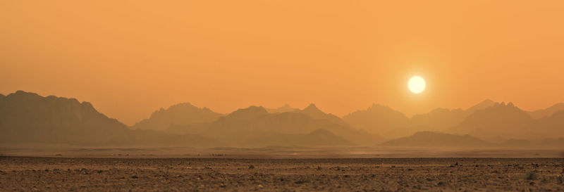 Scenic view of mountains against sky during sunset