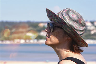 Side view of woman wearing hat