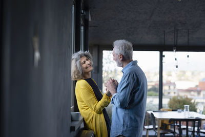 Rear view of people standing at home