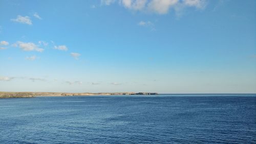 Scenic view of sea against blue sky