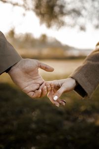 Low section of man holding hands