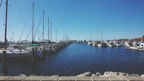 Sailboats in sea against clear sky